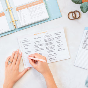 Fridge Meal Plan Pad being filled out with recipe binder opened