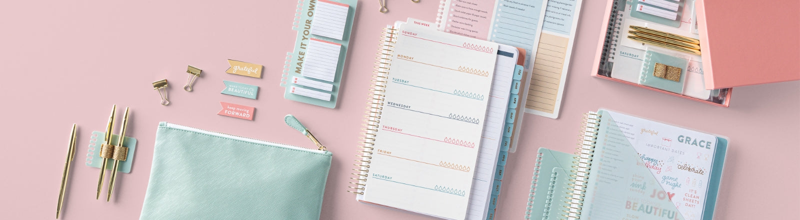 home planning items on pink background