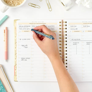 26-27 pink work planner being written in