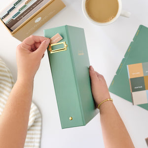 green recipe binder tab being put in