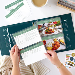 navy recipe binder with recipe cards being held