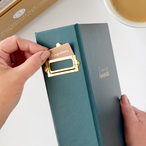 navy recipe binder with label being put in