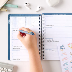 blue student planner being written in