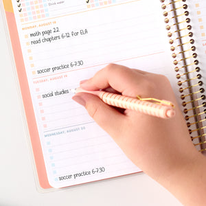 pink student planner writing close up