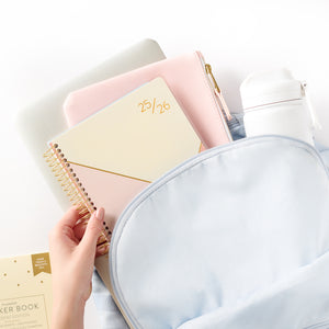 pink student planner in backpack