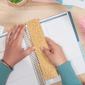 3 pack floral bookmarks being put in planner