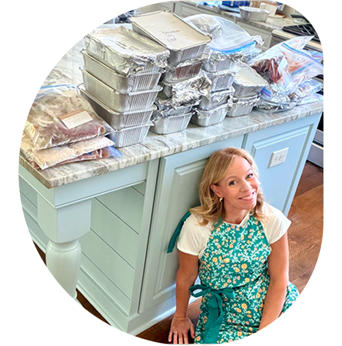 Laurie with freezer meals on table