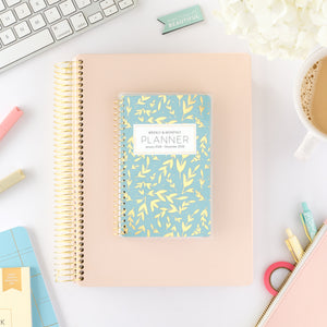 2026 blue leaf pocket calendar on top of blush home planner