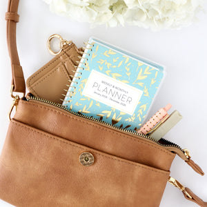 blue leaf pocket calendar in purse close up