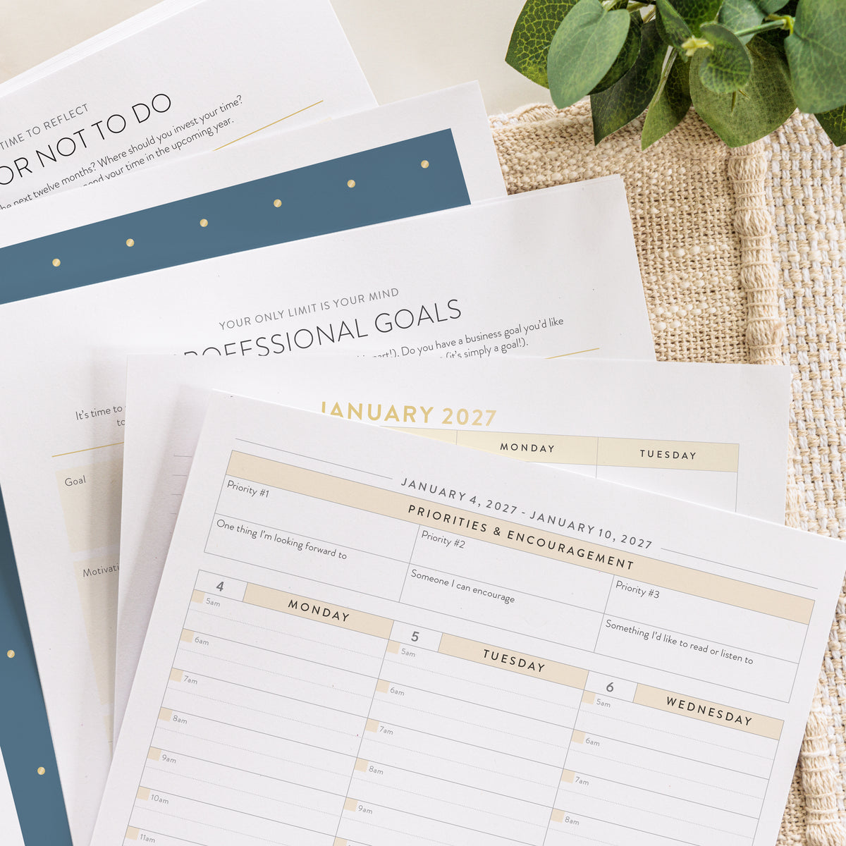 2027 digital work planner pages printed out on table