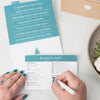 Recipe cards and someone filling out Grocery List