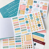 Menu Planning Sticker Book with stickers and recipe cards on counter