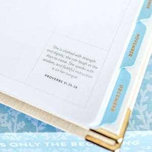 Work Planner close up of scripture verse Proverbs 31:23-24