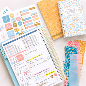 Home Planner opened to weekly calendar along with Sticker Pages, Bookmarks, Ruler and Pocket Calendar
