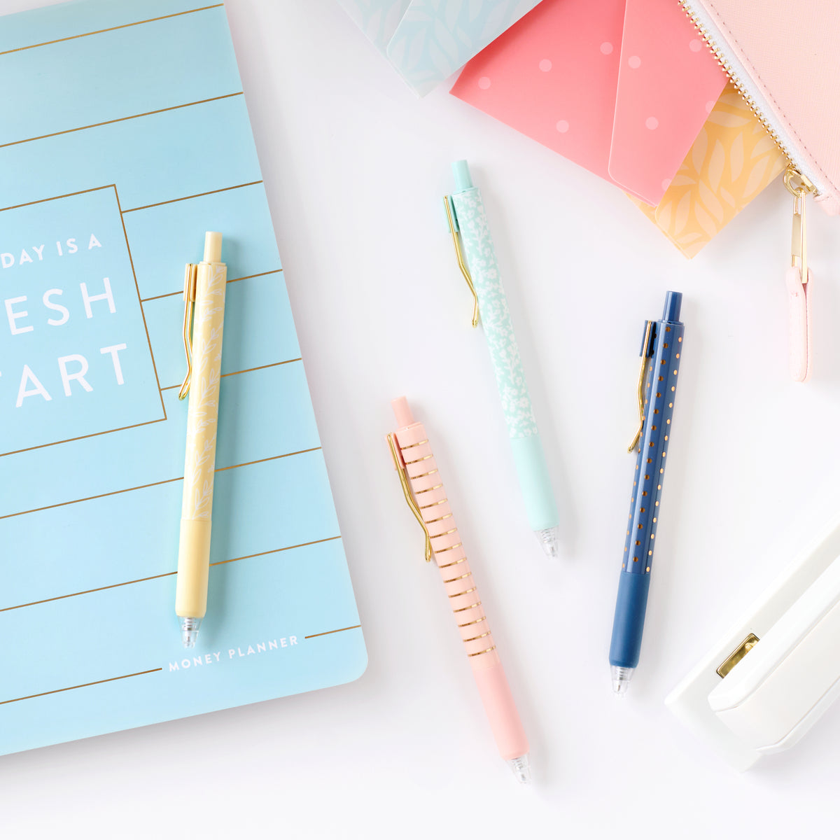 gel pen set on desk with money planner 