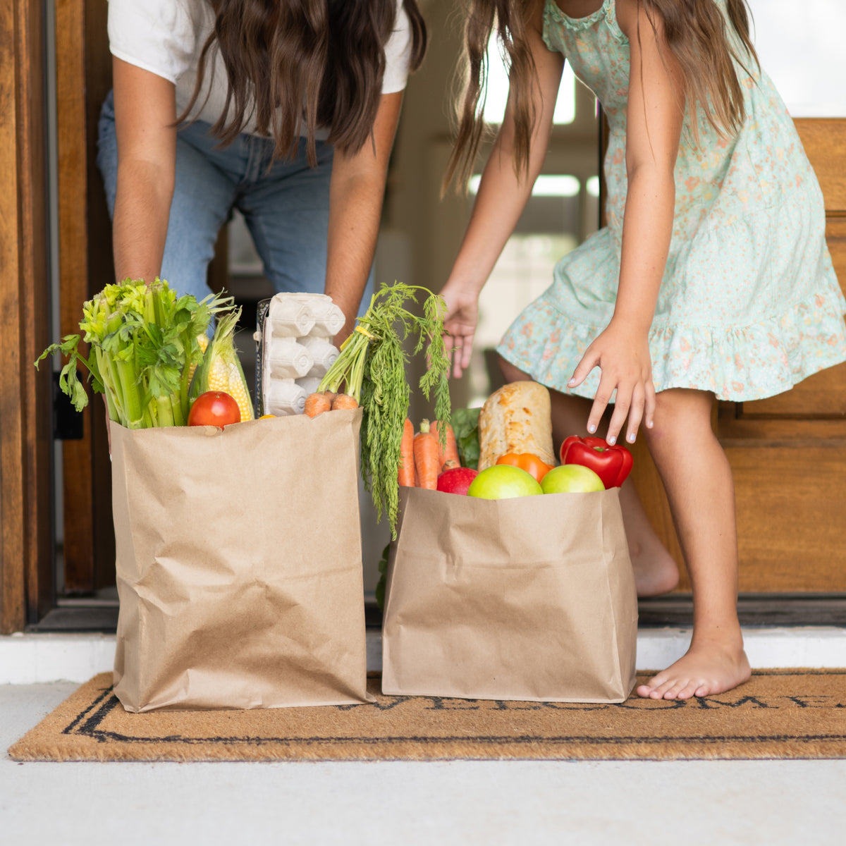 mom and daughter picking up groceries