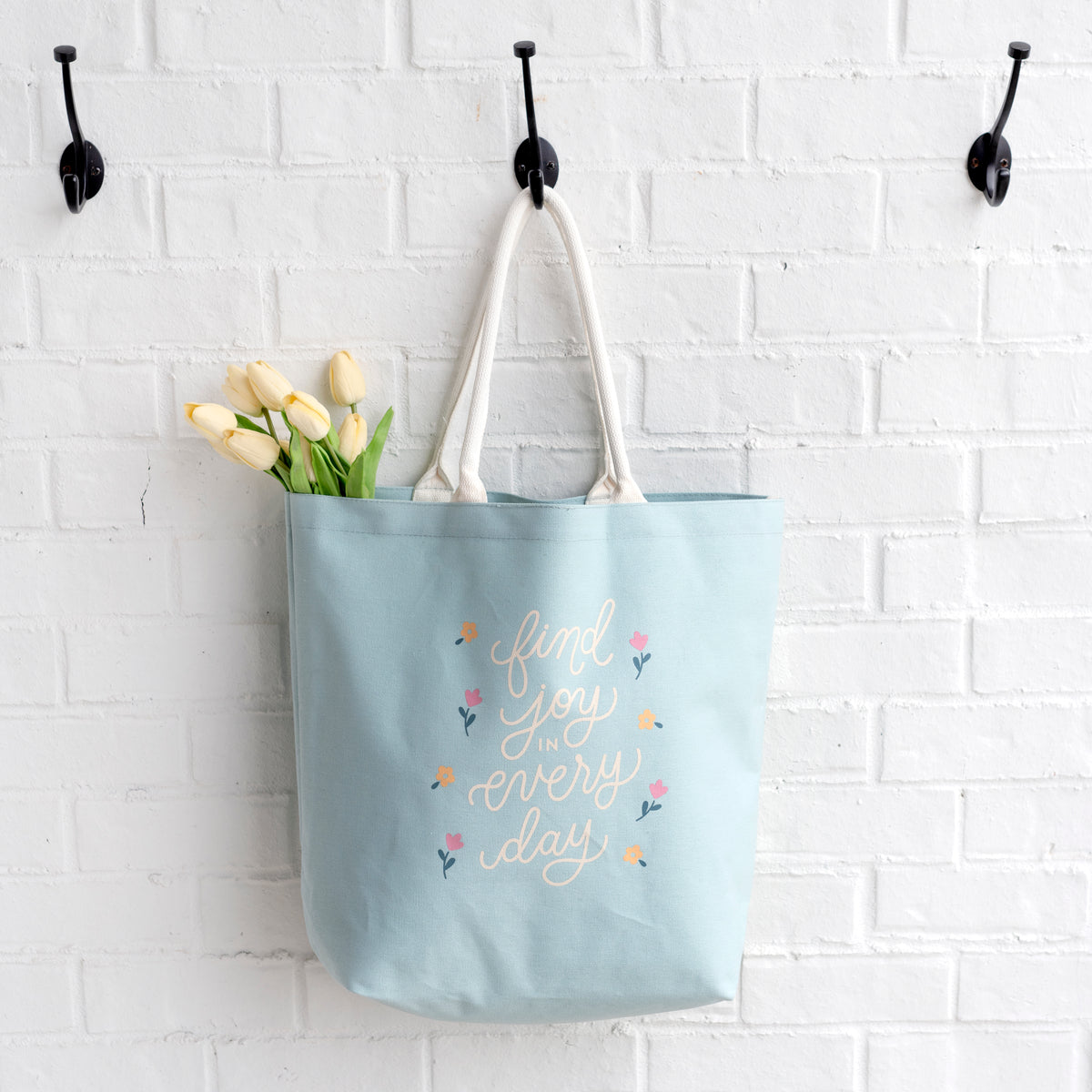 joy canvas tote hanging on hook