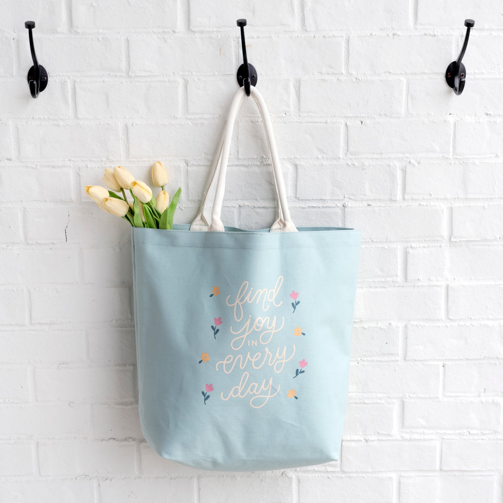 joy canvas tote hanging on hook