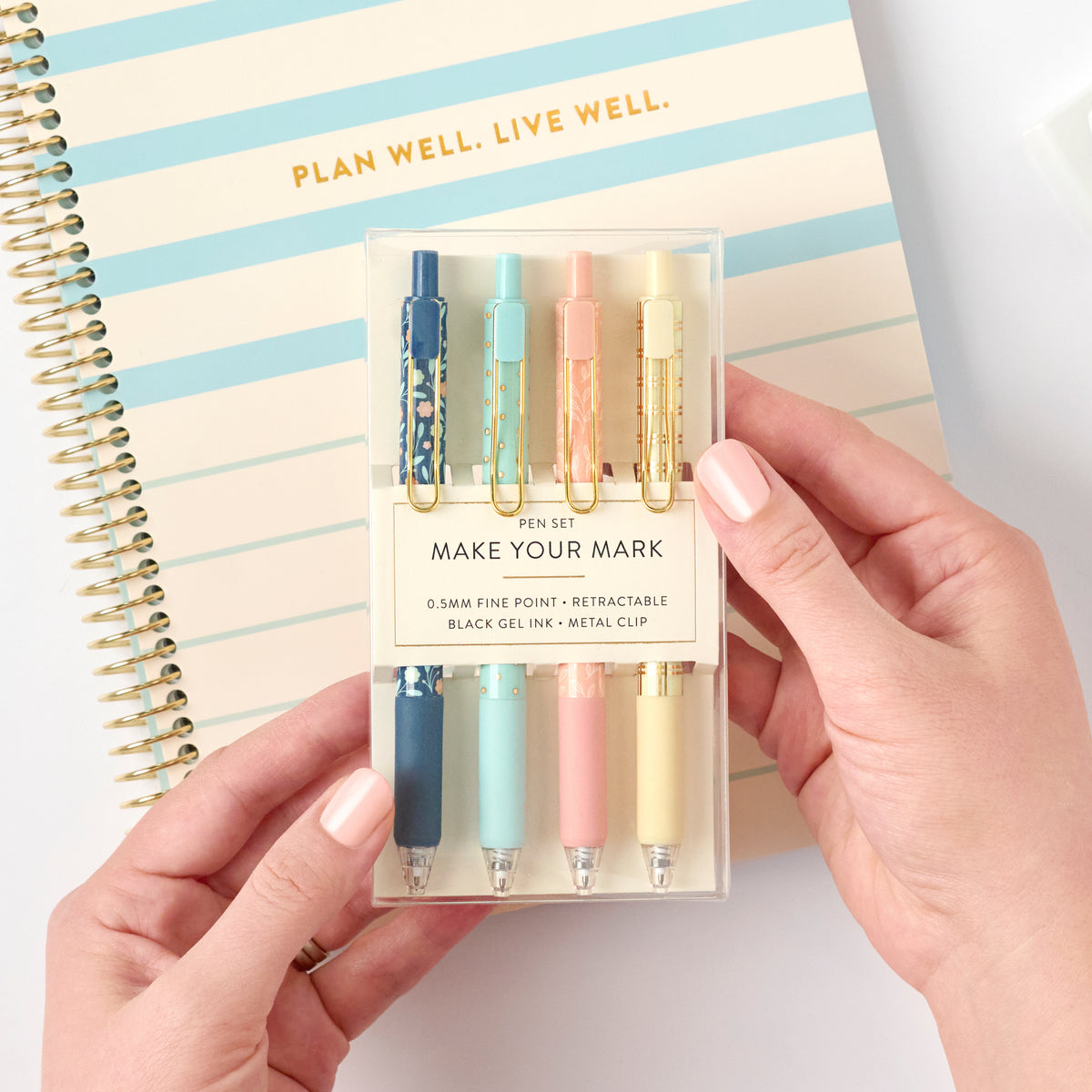 2nd edition gel pens being held with money planner