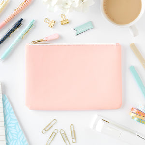 blush zipper pouch on desk