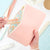 blush zipper pouch on desk