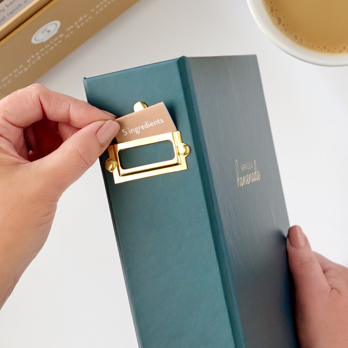 navy recipe binder with label being put in