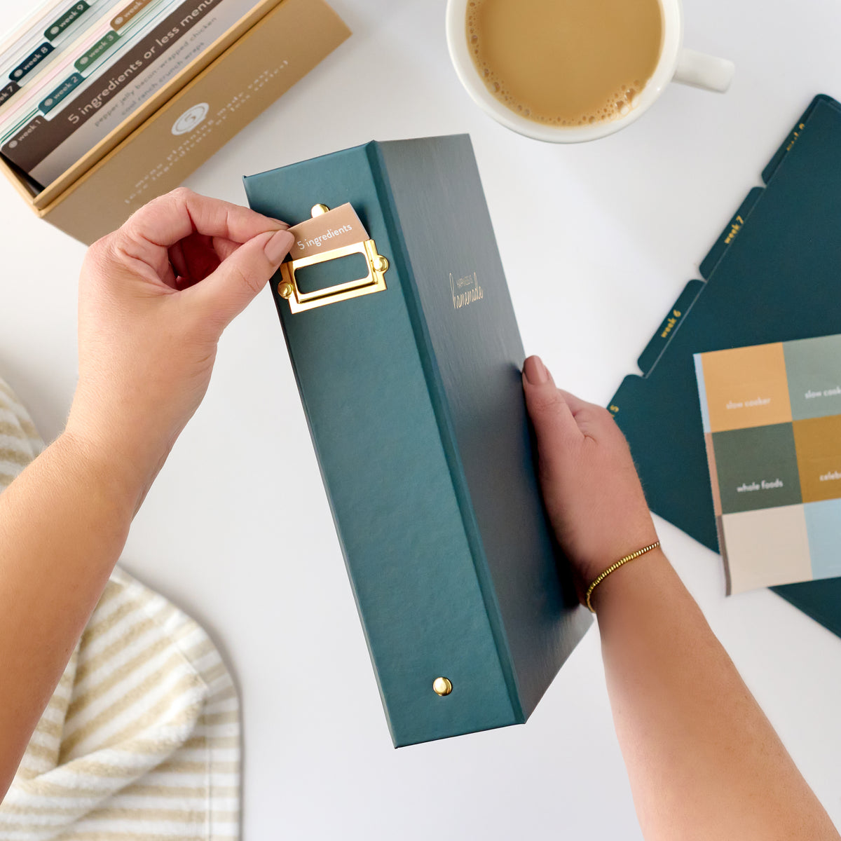 navy recipe binder with tab being put in