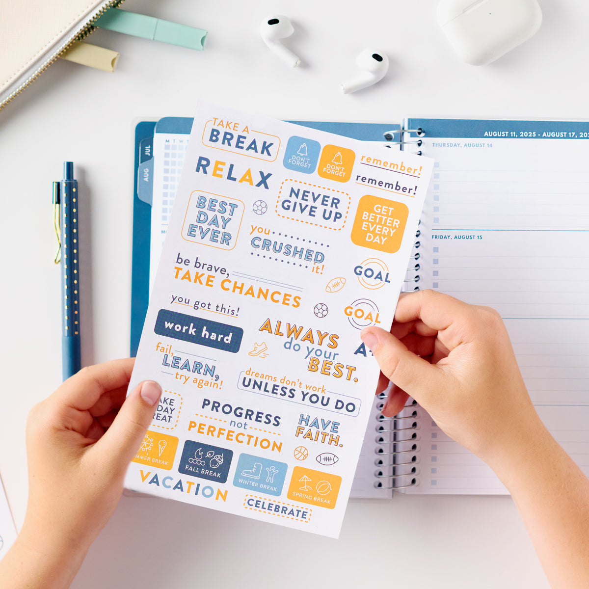 blue student planner stickers behind held