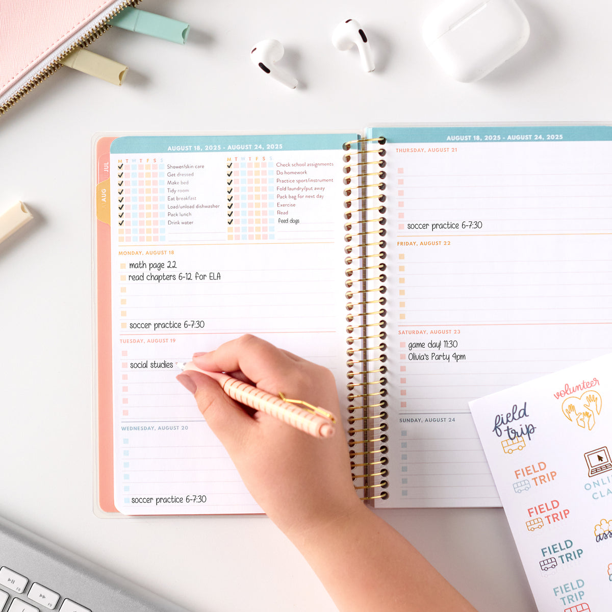 pink student planner being written in