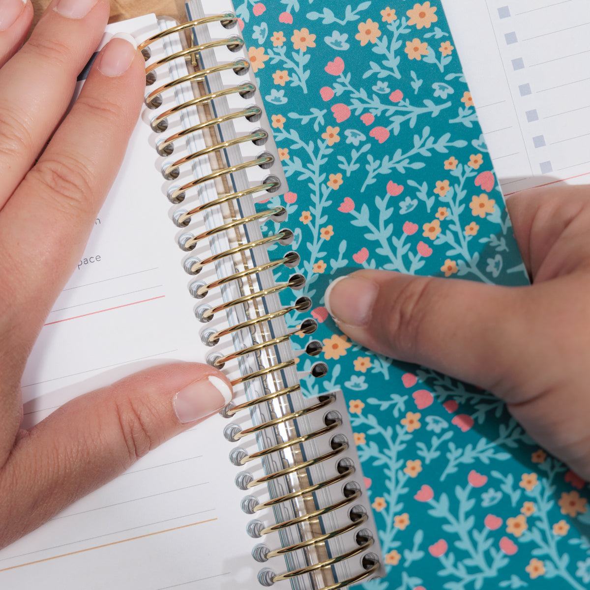 3 pack floral bookmarks being put in planner
